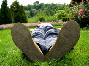 a person lying on the back in the garden having a break