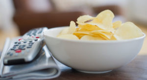 remote control and bowl of chips